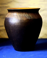 a black slipped covered ceramic vases with scraffitto decoration