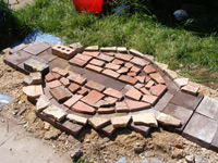 Base of the kiln with brick markers outlining the interior layout